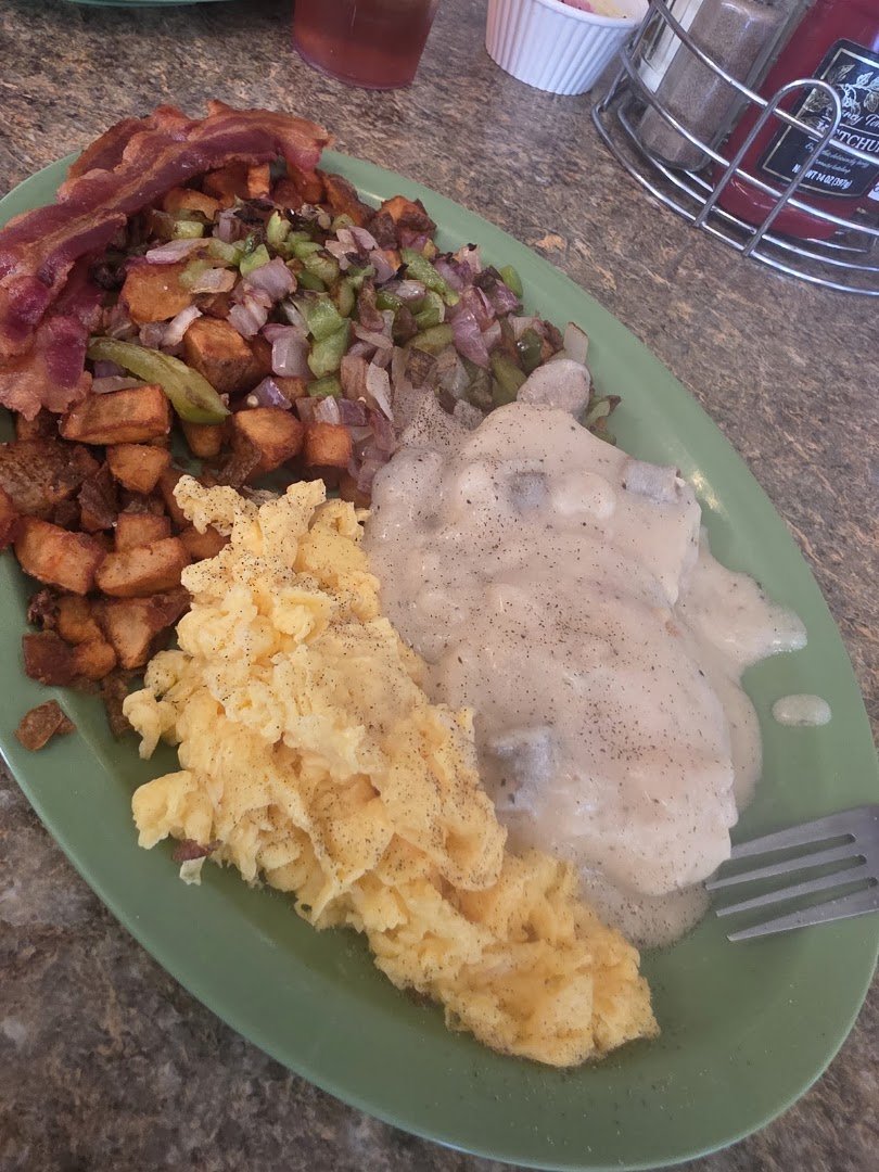 Cozy diner tables with simple breakfast plates.